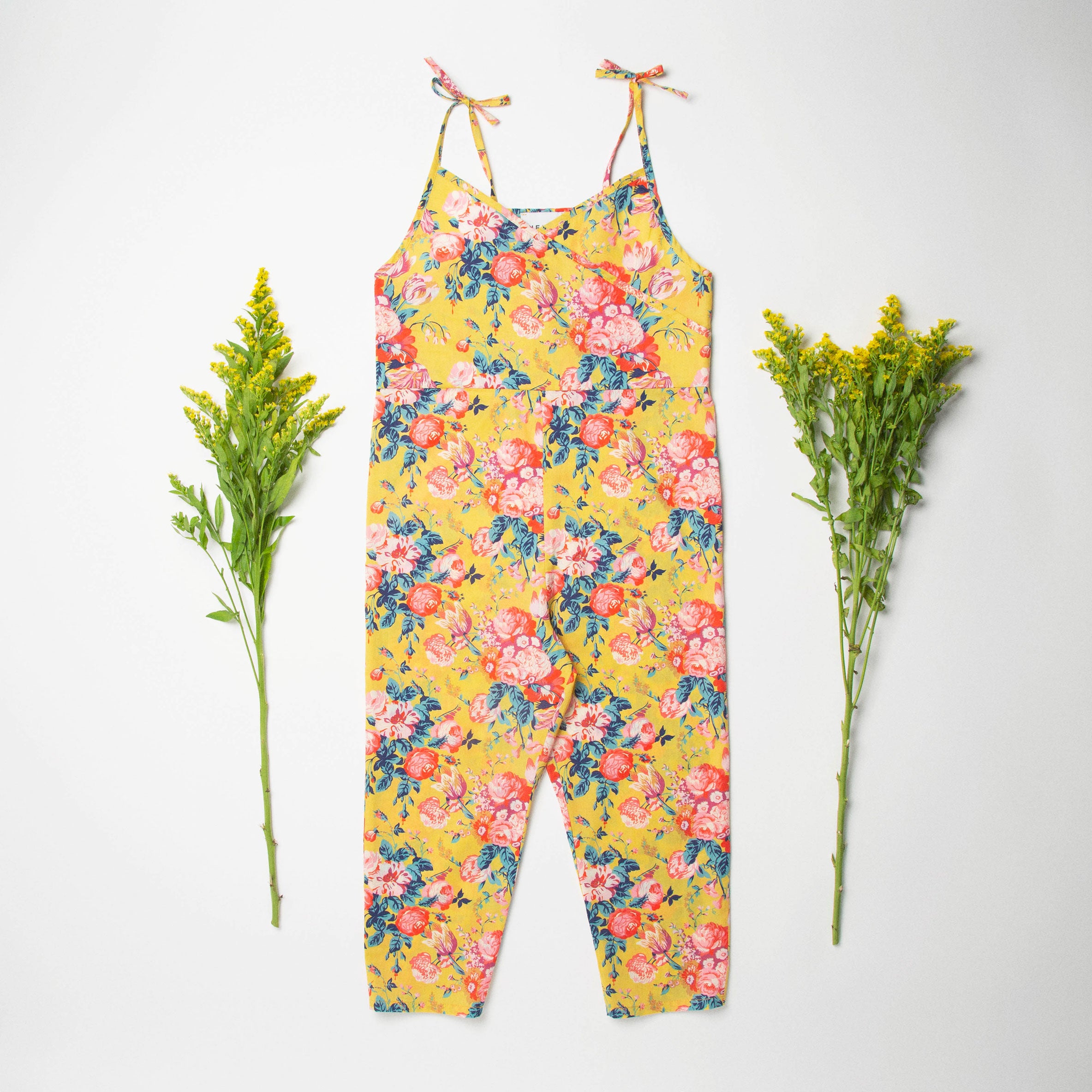 Comfy jumpsuit with loosely fitted wrap over top and tie up shoulder straps. Loose fitting straight leg trousers can be styled with a rolled up hem, turned down for growth spurts. Made from beautifully soft, Magical Bouquet Liberty print linen.