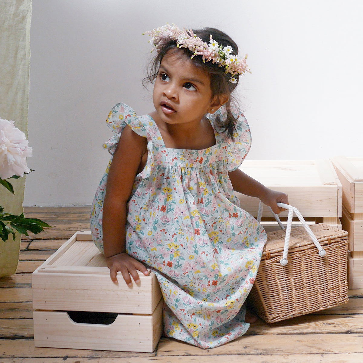 Ruffle sleeve summer dress with square empire line and loose, floaty fit. Attached gathered skirt sits at or below the knee to create a full shape. Made from beautifully soft Liberty print California Bloom tana lawn cotton.