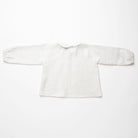 Loose fit, raglan sleeve white Linen blouse, with long elasticated sleeves, Peter Pan collar and single mother of pearl button at the back of the neck.  