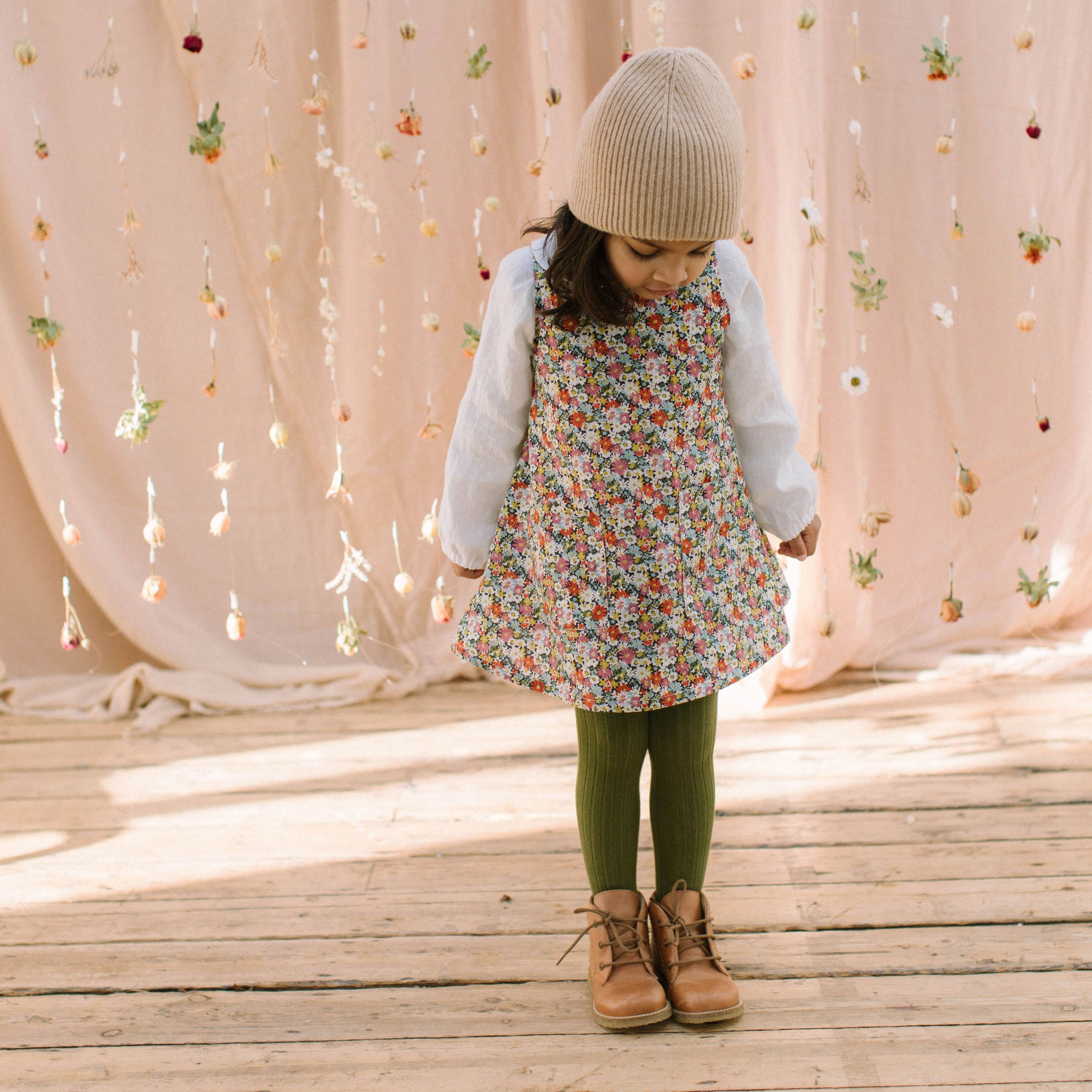 Simple A-line shaped pinafore dress with front pockets and tie at the back of the neck. Designed to sit above the knee and is perfect layered over an NQ blouse or stripped back in warmer weather. Made from beautiful Libby Liberty print tana lawn cotton.
