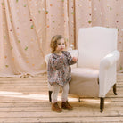All in one romper, with long full elasticated sleeves and gathered neck to create a full, loose body shape. Closes at the back with single mother of pearl button, has elasticated leg holes and poppers for ease of opening. Designed to sit at the top of the thigh, perfect layered over tights in cooler weather and without in the summer. Made from Emery Walker Liberty print tana lawn cotton.