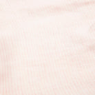 All in one romper, with short puffed elasticated sleeves and gathered neck to create a full, loose body shape. Closes at the back with single mother of pearl button, has elasticated leg holes and poppers for ease of opening. Designed to sit at the top of the thigh, perfect layered over tights in cooler weather and without in the summer. Made from super soft pale pink stripe linen.