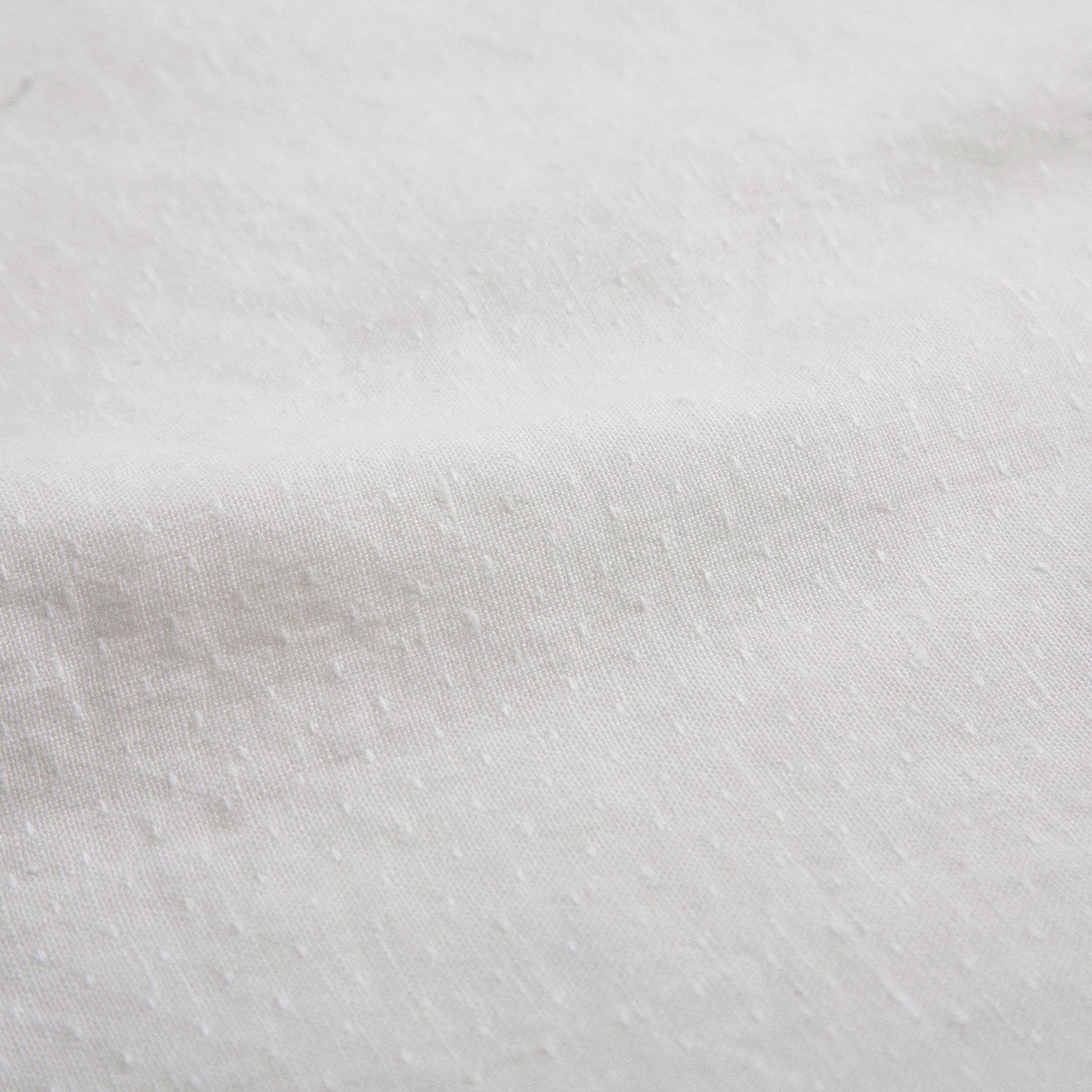 Loose fit, raglan sleeve white Linen blouse, with long elasticated sleeves, Peter Pan collar and single mother of pearl button at the back of the neck. 