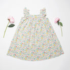 Ruffle sleeve summer dress with square empire line and loose, floaty fit. Attached gathered skirt sits at or below the knee to create a full shape. Made from beautifully soft Liberty print California Bloom tana lawn cotton.