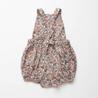 All in one romper, with bib front, elasticated waist and full bloomers with elasticated leg holes and poppers. Straps tie through loops at the back so fully adjustable (18-24M / 3-4Y). Smaller sizes fasten through a single button on the back, with buttonholes to adjust strap length (3-6M /6-12M /12-18M). Designed to sit at the top of the thigh, perfect paired with tights in winter and without in the summer. Made from Emery Walker Liberty print tana lawn cotton.