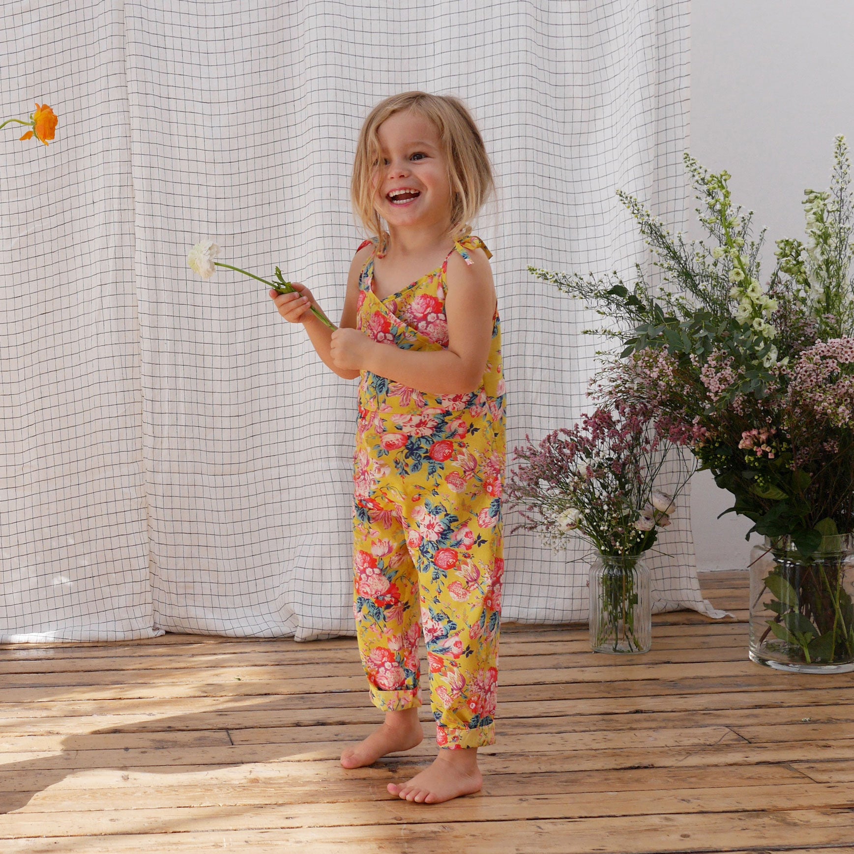 Comfy jumpsuit with loosely fitted wrap over top and tie up shoulder straps. Loose fitting straight leg trousers can be styled with a rolled up hem, turned down for growth spurts. Made from beautifully soft, Magical Bouquet Liberty print linen.