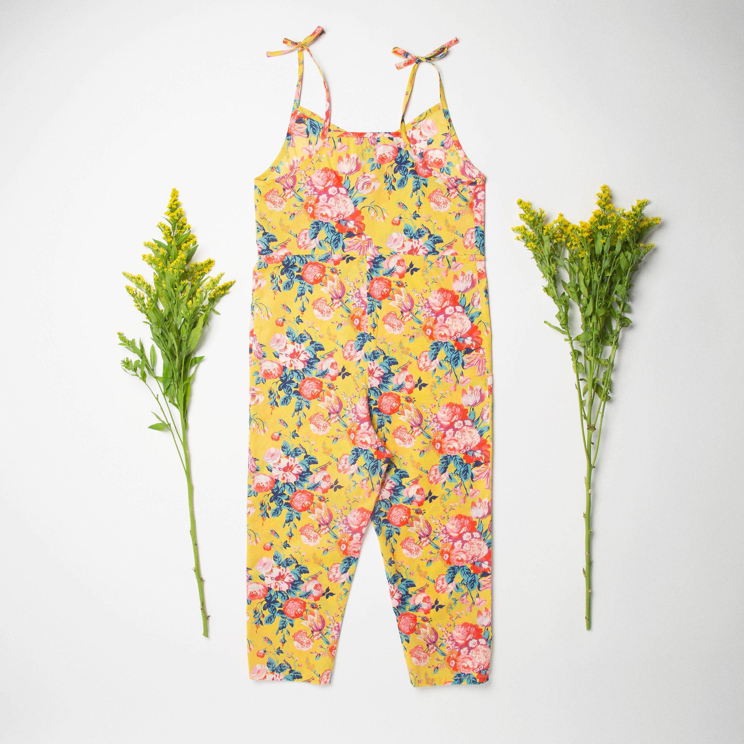Comfy jumpsuit with loosely fitted wrap over top and tie up shoulder straps. Loose fitting straight leg trousers can be styled with a rolled up hem, turned down for growth spurts. Made from beautifully soft, Magical Bouquet Liberty print linen.