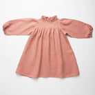 Full, floaty dress, with high empire line, full elasticated sleeves, small neck ruffle and mother of pearl buttons down the back yolk. Attached gathered skirt sits at a longer length below the knee. Designed to be oversized for a stylish, comfortable fit. Made from beautifully soft, dusty rose linen.