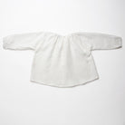 Loose fit, raglan sleeve peasant blouse, with puffed, full length sleeves, elasticated cuffs and mother of pearl button at the back of the neck. Neck line is gathered, to create an oversized style and comfortable fit. Made from textured milk polka dot linen.
