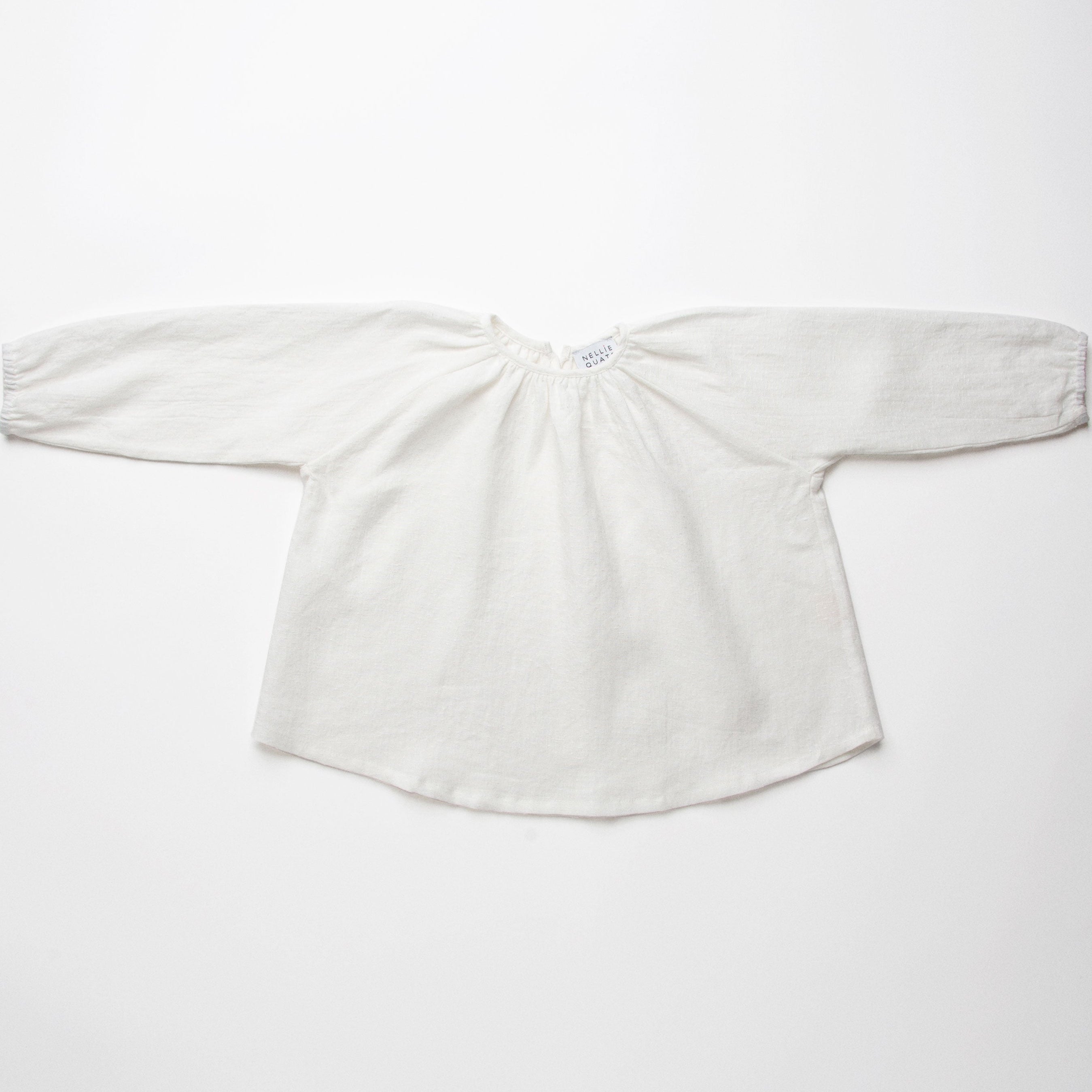 Loose fit, raglan sleeve peasant blouse, with puffed, full length sleeves, elasticated cuffs and mother of pearl button at the back of the neck. Neck line is gathered, to create an oversized style and comfortable fit. Made from textured milk polka dot linen.