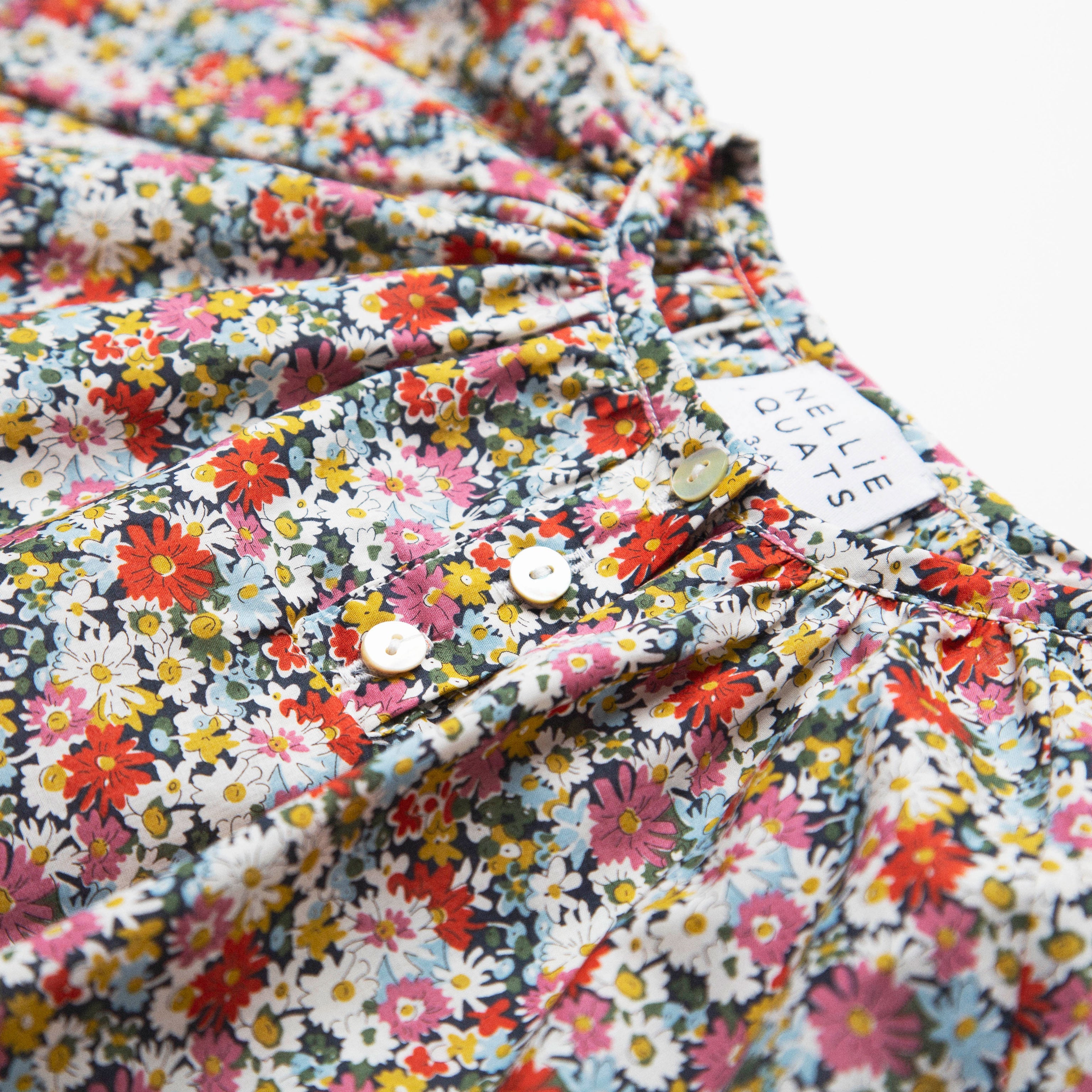 Loose fit, raglan sleeve peasant dress, with puffed, long, full sleeves, elasticated cuffs and mother of pearl button up front. Neck line is gathered, to create an oversized style and comfortable fit. Two pockets sit at the front of the dress, perfect for storing treasures. Designed to sit above the knee and made from beautiful Libby Liberty print tana lawn cotton.