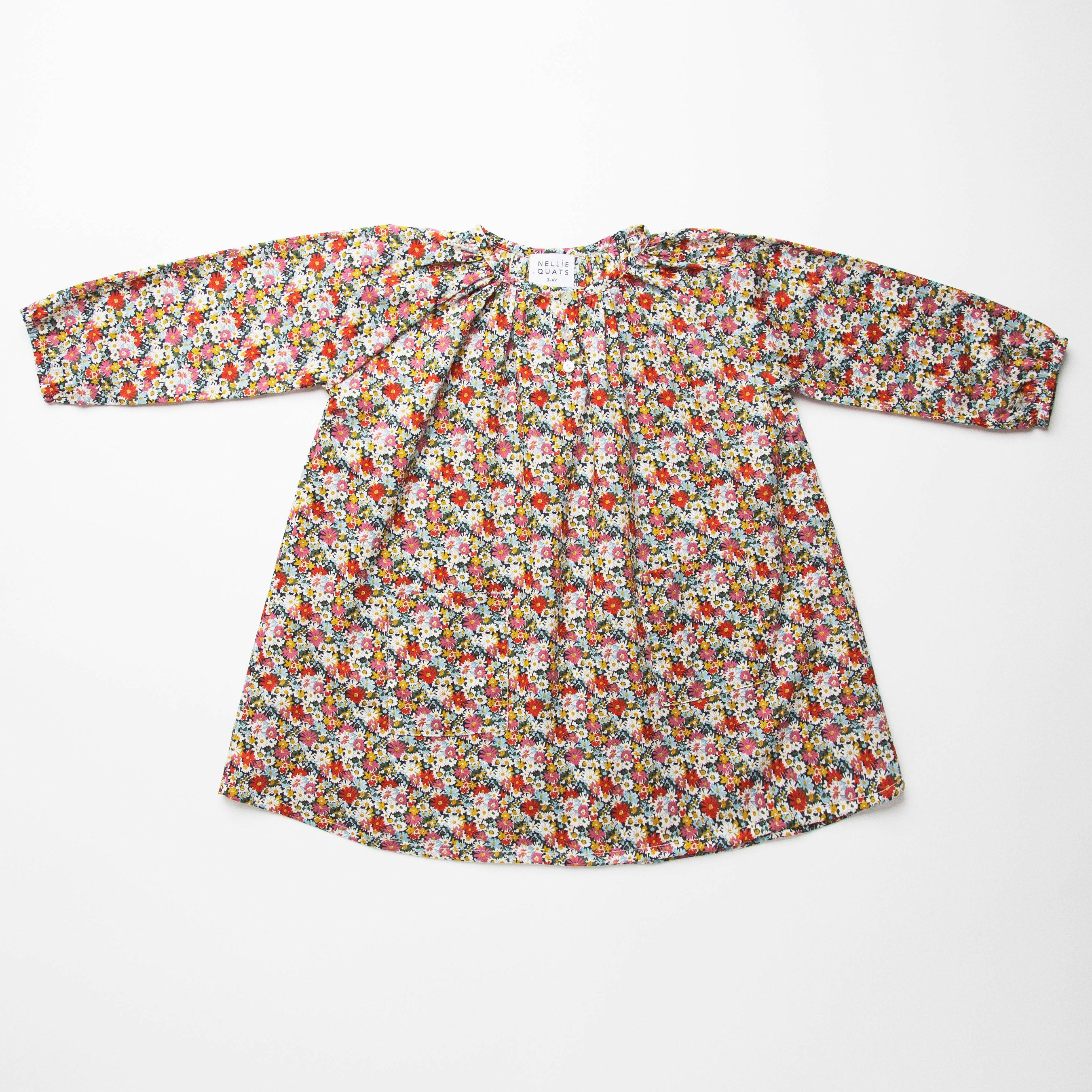 Loose fit, raglan sleeve peasant dress, with puffed, long, full sleeves, elasticated cuffs and mother of pearl button up front. Neck line is gathered, to create an oversized style and comfortable fit. Two pockets sit at the front of the dress, perfect for storing treasures. Designed to sit above the knee and made from beautiful Libby Liberty print tana lawn cotton.