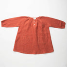 Loose fit, raglan sleeve peasant dress, with puffed, long, full sleeves, elasticated cuffs and mother of pearl button up front. Neck line is gathered, to create an oversized style and comfortable fit. Two pockets sit at the front of the dress, perfect for storing treasures. Designed to sit above the knee and made from super soft rust check linen.