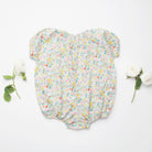 All in one romper, with short puffed elasticated sleeves and gathered neck to create a full, loose body shape. Closes at the back with single mother of pearl button, has elasticated leg holes and poppers for ease of opening. Designed to sit at the top of the thigh, perfect layered over tights in cooler weather and without in the summer. Made from beautiful California Bloom Liberty print tana lawn cotton.