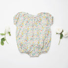 All in one romper, with short puffed elasticated sleeves and gathered neck to create a full, loose body shape. Closes at the back with single mother of pearl button, has elasticated leg holes and poppers for ease of opening. Designed to sit at the top of the thigh, perfect layered over tights in cooler weather and without in the summer. Made from beautiful California Bloom Liberty print tana lawn cotton.