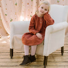 Loose fit, raglan sleeve peasant dress, with puffed, long, full sleeves, elasticated cuffs and mother of pearl button up front. Neck line is gathered, to create an oversized style and comfortable fit. Two pockets sit at the front of the dress, perfect for storing treasures. Designed to sit above the knee and made from super soft rust check linen.