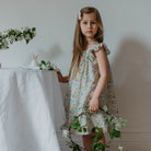 Ruffle sleeve summer dress with square empire line and loose, floaty fit. Attached gathered skirt sits at or below the knee to create a full shape. Made from beautifully soft Liberty print California Bloom tana lawn cotton.