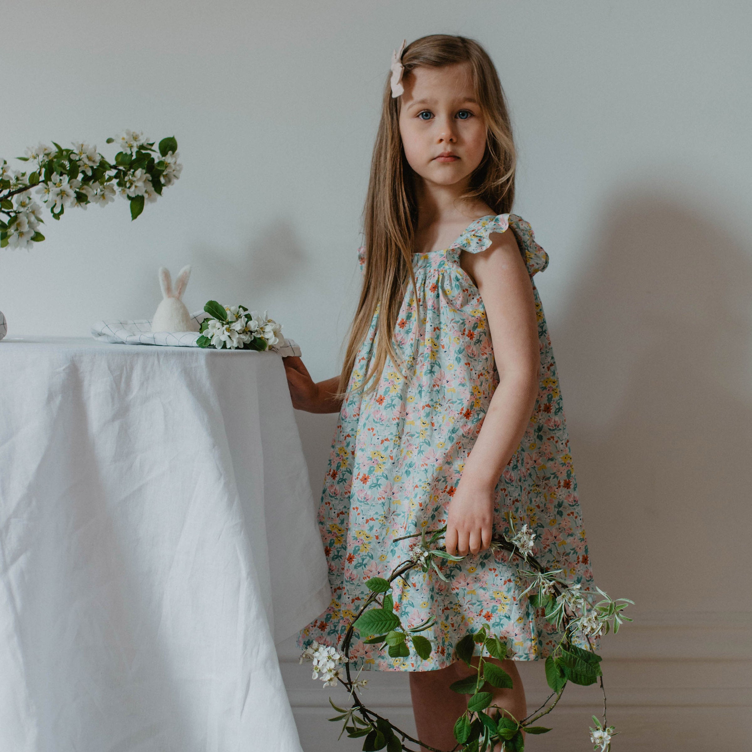 Ruffle sleeve summer dress with square empire line and loose, floaty fit. Attached gathered skirt sits at or below the knee to create a full shape. Made from beautifully soft Liberty print California Bloom tana lawn cotton.