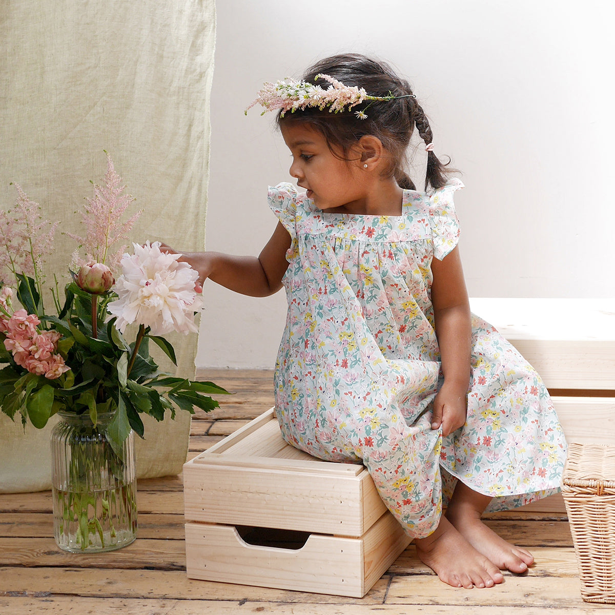 Ruffle sleeve summer dress with square empire line and loose, floaty fit. Attached gathered skirt sits at or below the knee to create a full shape. Made from beautifully soft Liberty print California Bloom tana lawn cotton.