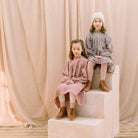 Full, floaty dress, with high empire line, full elasticated sleeves, small neck ruffle and mother of pearl buttons down the back yolk. Attached gathered skirt sits at a longer length below the knee. Designed to be oversized for a stylish, comfortable fit. Made from beautifully soft, dusty rose linen.