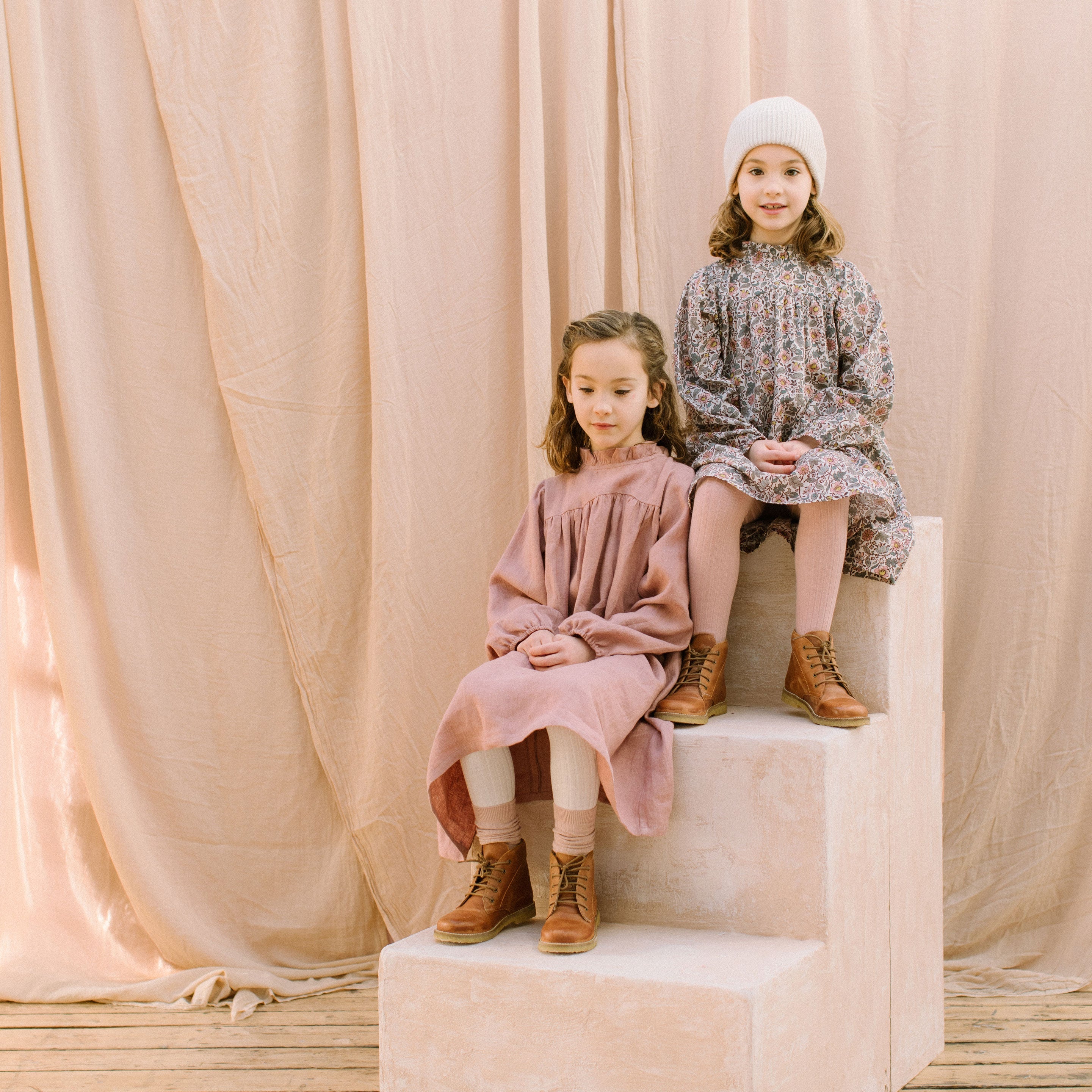Full, floaty dress, with high empire line, full elasticated sleeves, small neck ruffle and mother of pearl buttons down the back yolk. Attached gathered skirt sits at a longer length below the knee. Designed to be oversized for a stylish, comfortable fit. Made from beautifully soft, dusty rose linen.