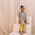 Loose fit, raglan sleeve peasant dress, with puffed, long, full sleeves, elasticated cuffs and mother of pearl button up front. Neck line is gathered, to create an oversized style and comfortable fit. Two pockets sit at the front of the dress, perfect for storing treasures. Designed to sit above the knee and made from beautiful Libby Liberty print tana lawn cotton.
