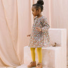 Loose fit, raglan sleeve peasant dress, with puffed, long, full sleeves, elasticated cuffs and mother of pearl button up front. Neck line is gathered, to create an oversized style and comfortable fit. Two pockets sit at the front of the dress, perfect for storing treasures. Designed to sit above the knee and made from beautiful Libby Liberty print tana lawn cotton.