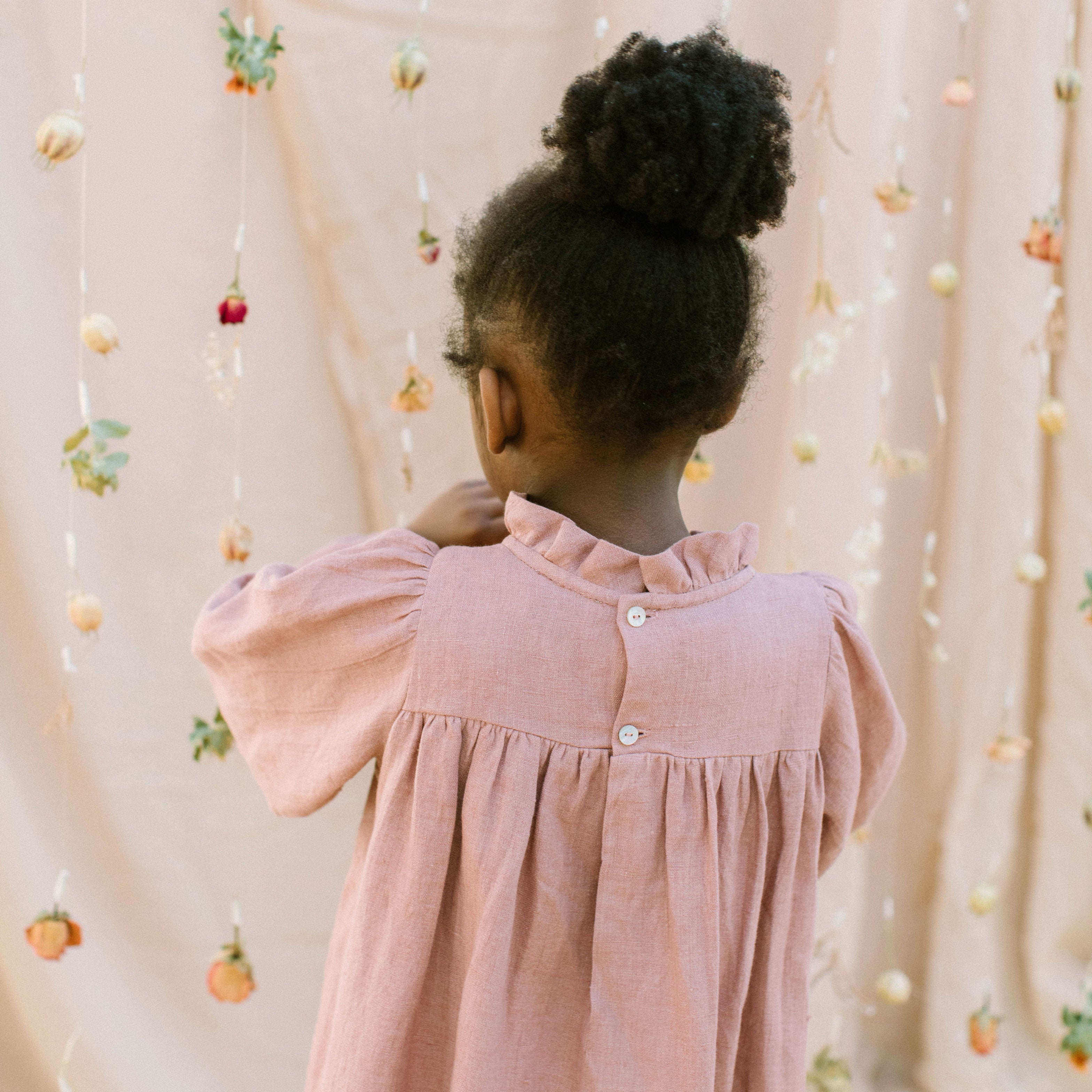 Full, floaty dress, with high empire line, full elasticated sleeves, small neck ruffle and mother of pearl buttons down the back yolk. Attached gathered skirt sits at a longer length below the knee. Designed to be oversized for a stylish, comfortable fit. Made from beautifully soft, dusty rose linen.