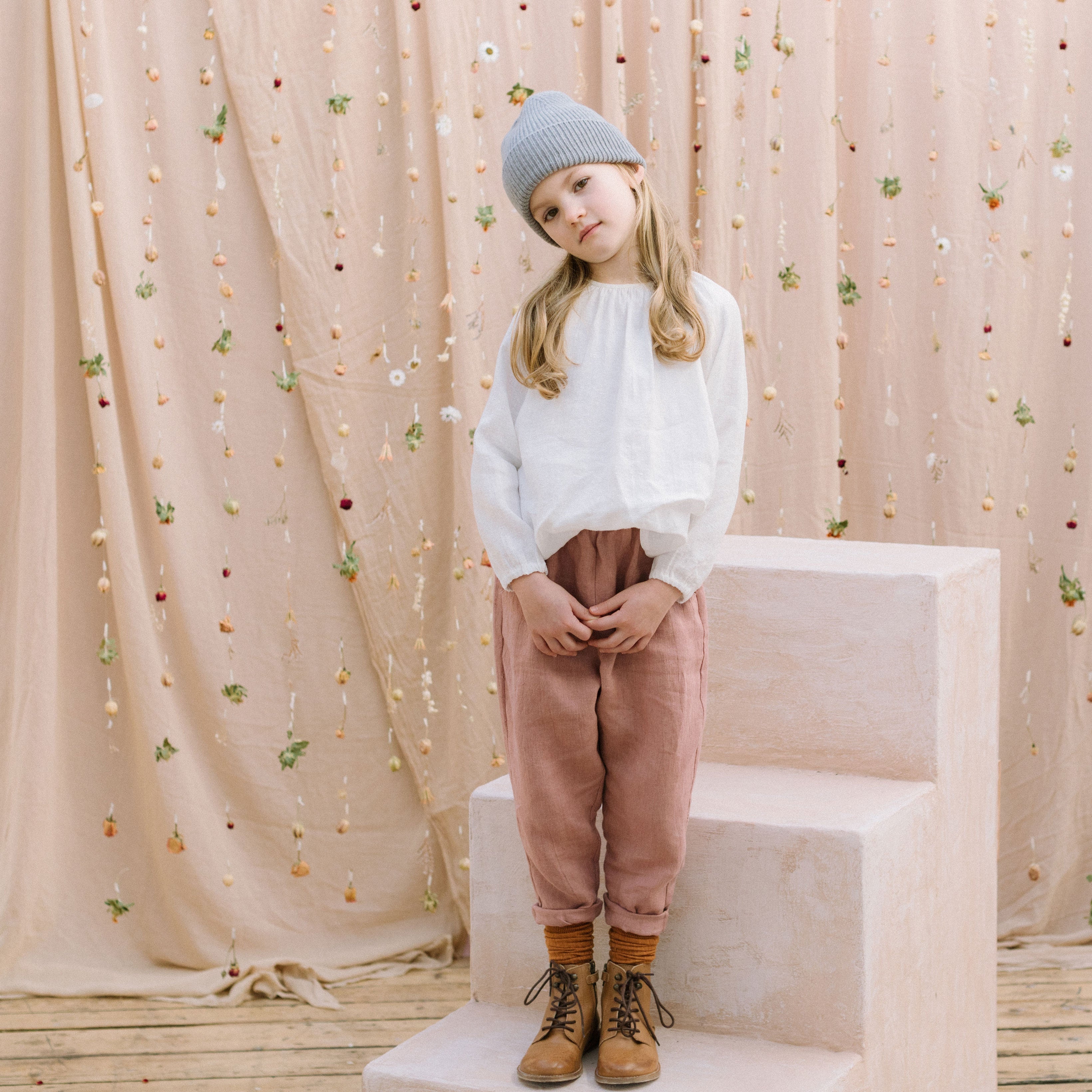 Loose fit, raglan sleeve peasant blouse, with puffed, full length sleeves, elasticated cuffs and mother of pearl button at the back of the neck. Neck line is gathered, to create an oversized style and comfortable fit. Made from textured milk polka dot linen.