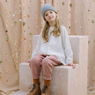 Loose fit, raglan sleeve peasant blouse, with puffed, full length sleeves, elasticated cuffs and mother of pearl button at the back of the neck. Neck line is gathered, to create an oversized style and comfortable fit. Made from textured milk polka dot linen.